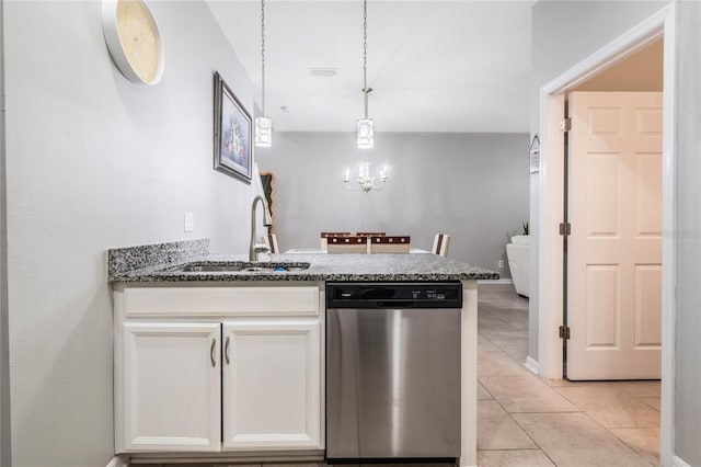 17523 Promenade Dr, Clermont, FL 34711 - kitchen with sink, dishwasher, white cabinetry, dark stone countertops, and hanging light fixtures