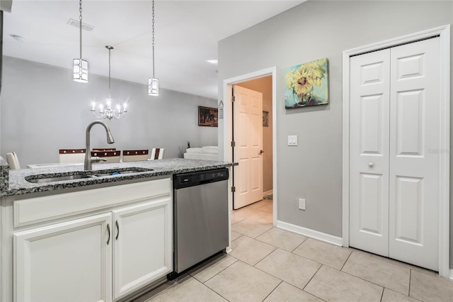 17523 Promenade Dr, Clermont, FL 34711 - kitchen with pendant lighting, white cabinetry, sink, dark stone countertops, and stainless steel dishwasher
