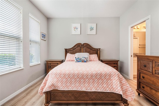17523 Promenade Dr, Clermont, FL 34711 - bedroom with connected bathroom and light hardwood / wood-style flooring