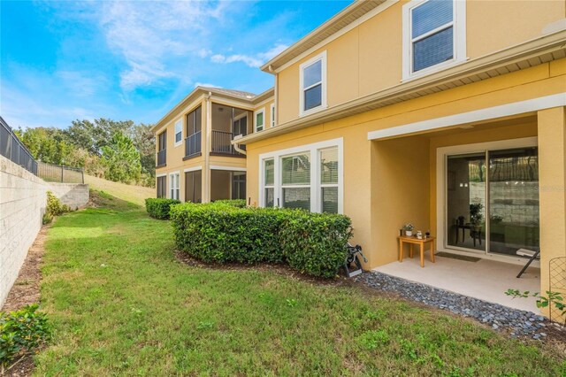 17523 Promenade Dr, Clermont, FL 34711 - rear view of house with a patio and a yard