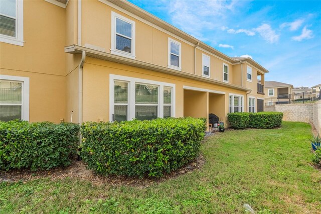 17523 Promenade Dr, Clermont, FL 34711 - back of property with a yard