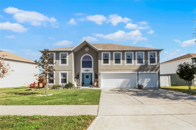 view of front of home with a garage, concrete driveway, a front lawn, and stucco siding