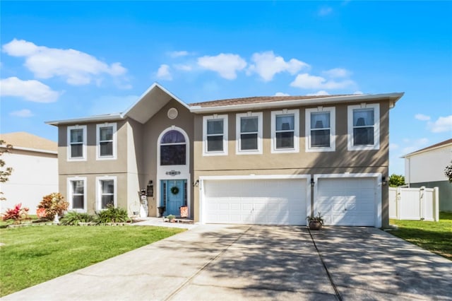 view of front of house with a front yard, driveway, an attached garage, and stucco siding