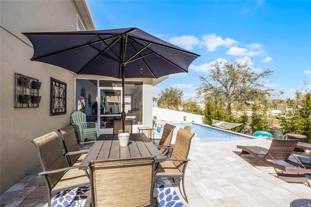 view of patio featuring outdoor dining area and a fenced in pool