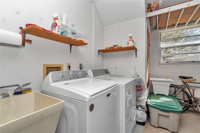 clothes washing area featuring washing machine and clothes dryer and sink