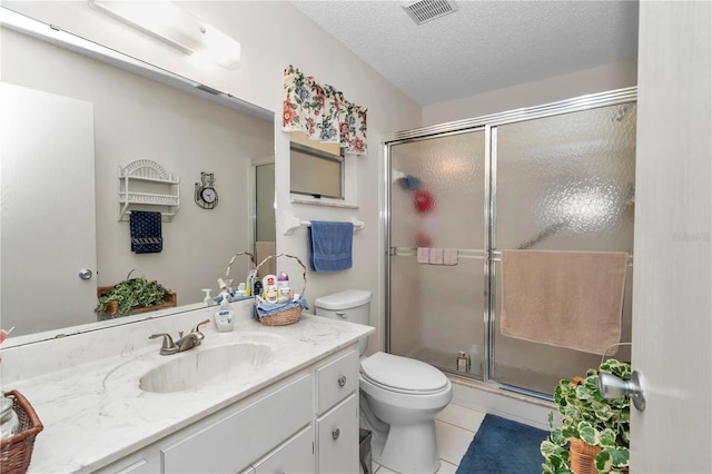 bathroom featuring vanity, walk in shower, toilet, tile patterned floors, and a textured ceiling