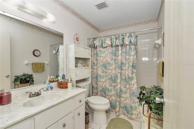 bathroom with tile patterned floors, toilet, a textured ceiling, vanity, and curtained shower