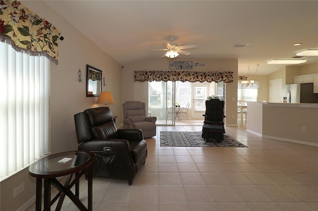 tiled living room with lofted ceiling and ceiling fan with notable chandelier