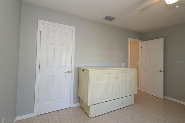 unfurnished bedroom featuring ceiling fan and light tile patterned flooring