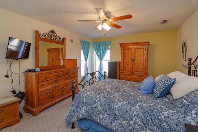 bedroom featuring ceiling fan and light colored carpet