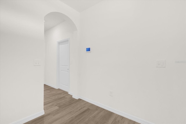 hallway with light hardwood / wood-style floors