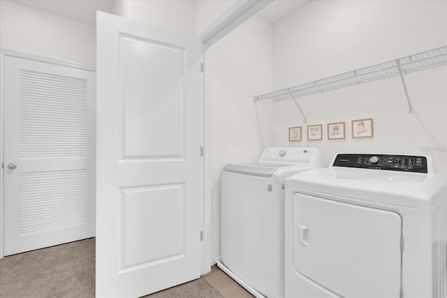 clothes washing area with washing machine and dryer