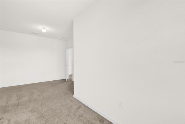 empty room featuring light colored carpet