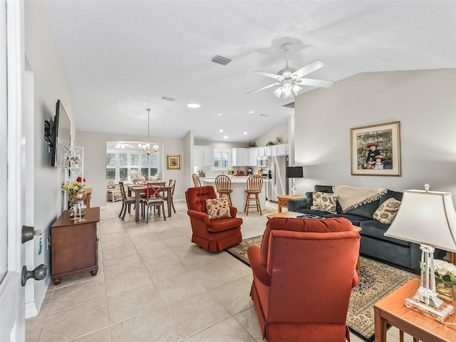 living room with ceiling fan with notable chandelier, light tile patterned flooring, and vaulted ceiling