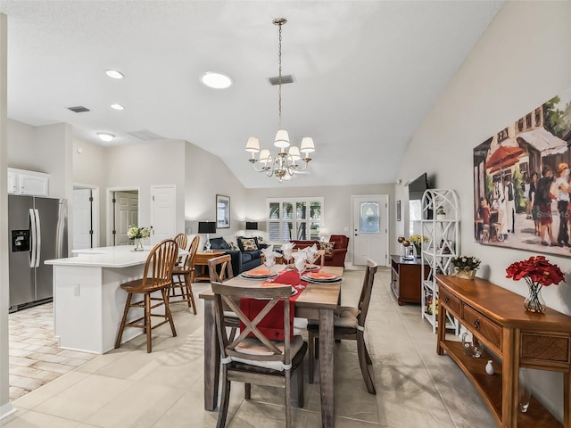 dining room featuring an inviting chandelier and lofted ceiling