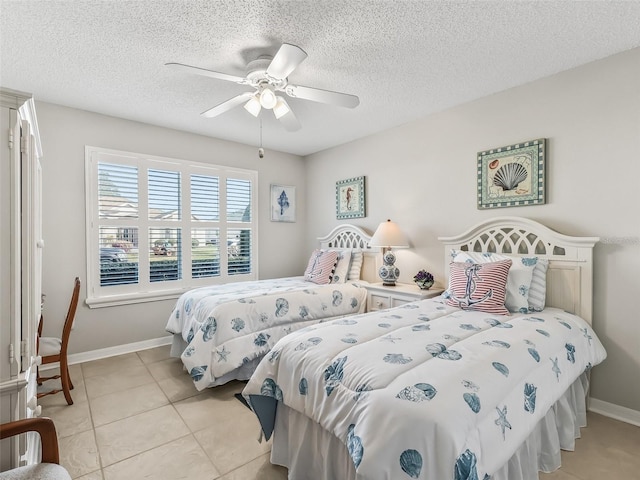 bedroom with ceiling fan, a textured ceiling, and light tile patterned floors