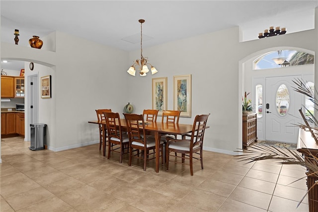 tiled dining room featuring a notable chandelier