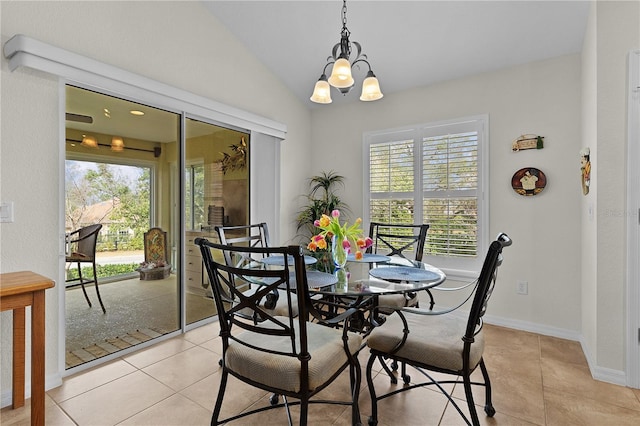 dining area featuring light tile patterned floors, vaulted ceiling, and plenty of natural light