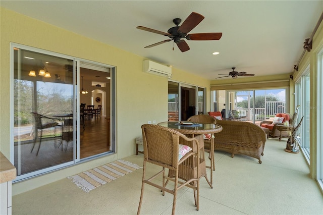 sunroom / solarium with ceiling fan and a wall mounted air conditioner