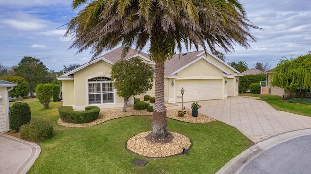 single story home featuring a garage and a front lawn