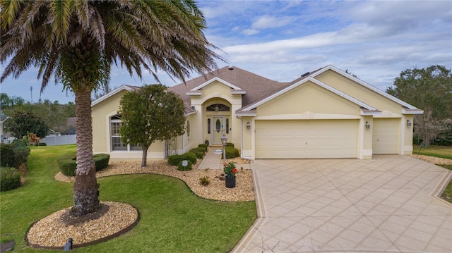 ranch-style house featuring a garage and a front lawn