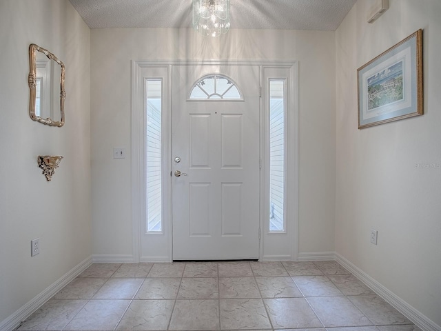 foyer featuring a textured ceiling