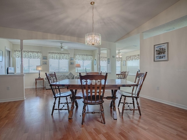 dining space featuring hardwood / wood-style flooring, plenty of natural light, ceiling fan, and vaulted ceiling