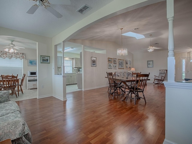 dining room featuring hardwood / wood-style flooring, a textured ceiling, and a wealth of natural light