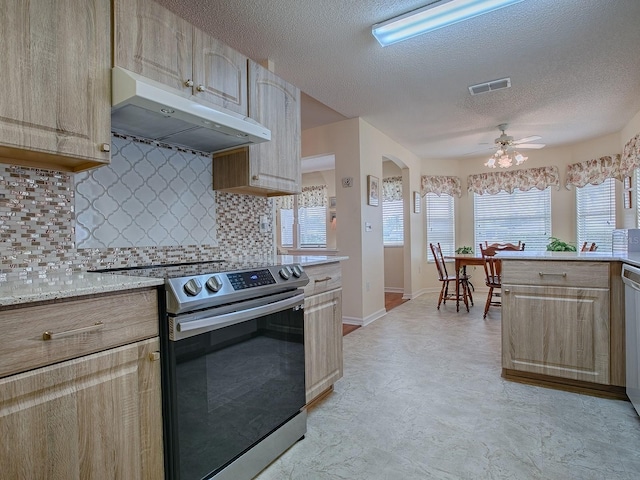 kitchen featuring stainless steel electric range oven, tasteful backsplash, ceiling fan, light brown cabinets, and a textured ceiling