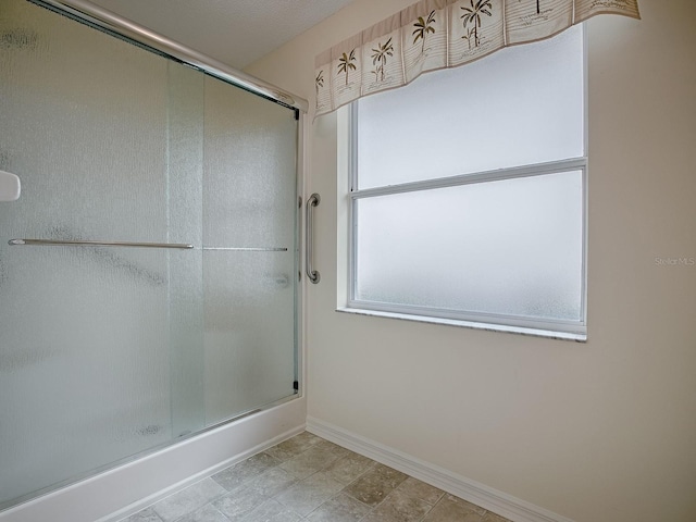 bathroom with a shower with shower door