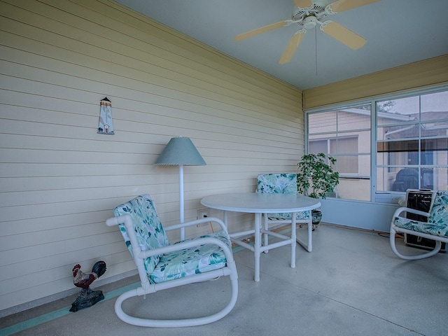 sunroom / solarium featuring ceiling fan