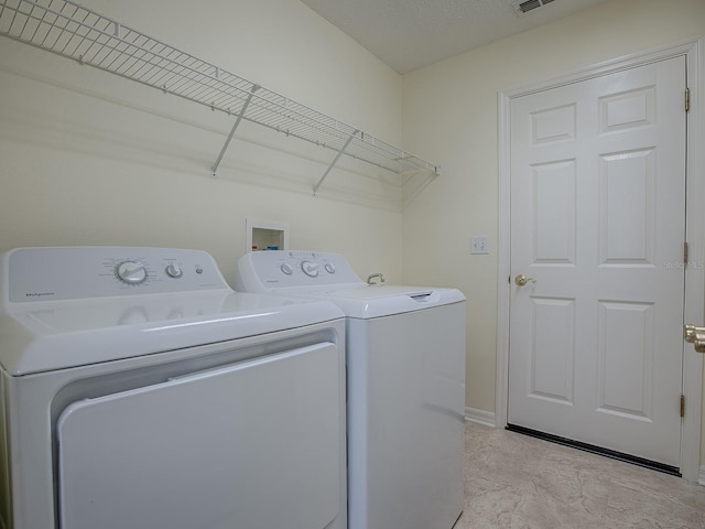 laundry area with washing machine and clothes dryer