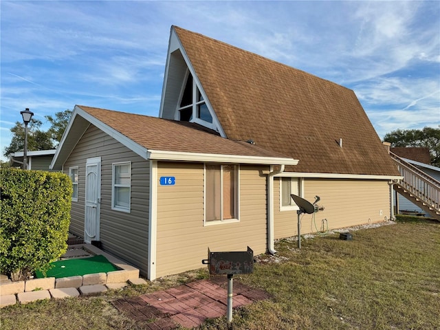 view of side of property with a yard