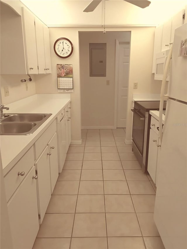 kitchen featuring white appliances, electric panel, white cabinets, light countertops, and a sink