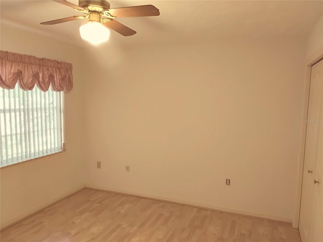 unfurnished room with light wood finished floors and a ceiling fan