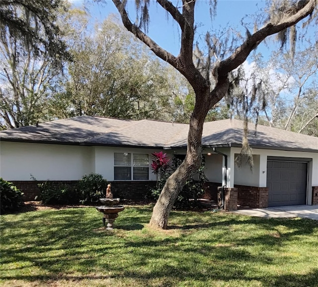 single story home with a garage, stucco siding, a front lawn, and brick siding