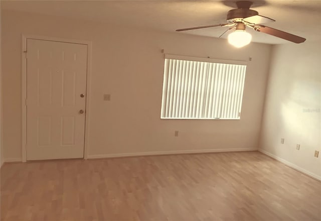 unfurnished room with baseboards and light wood-style floors