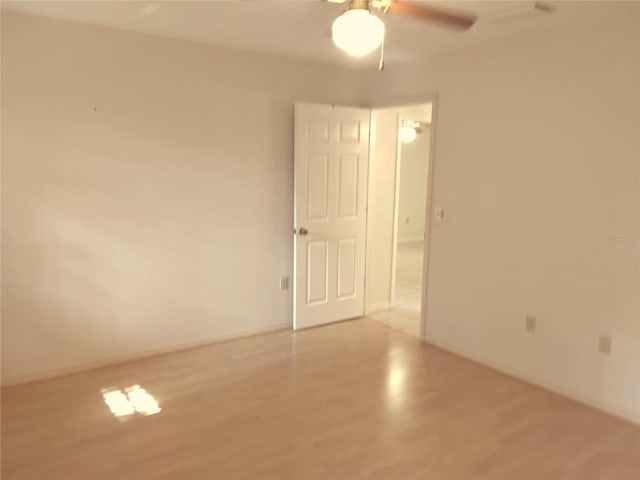 spare room with wood finished floors and a ceiling fan