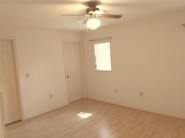 unfurnished room with light wood finished floors and a ceiling fan