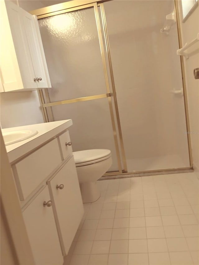 full bathroom featuring vanity, a shower stall, and toilet