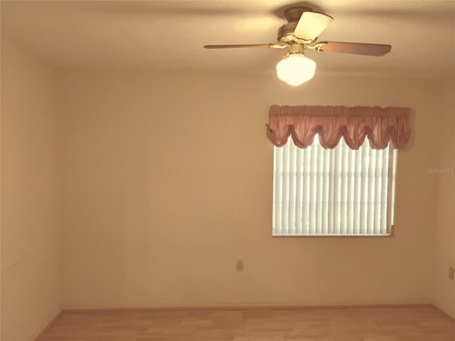 unfurnished room with ceiling fan and wood finished floors