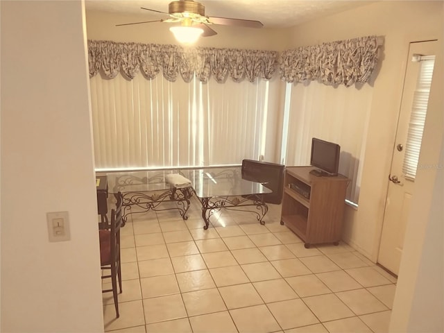 home office featuring light tile patterned floors and a ceiling fan