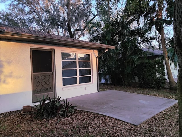 exterior space with a patio and stucco siding