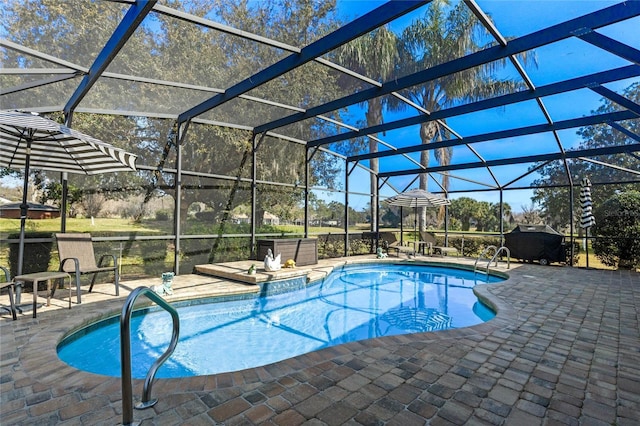 view of pool featuring a patio area and glass enclosure