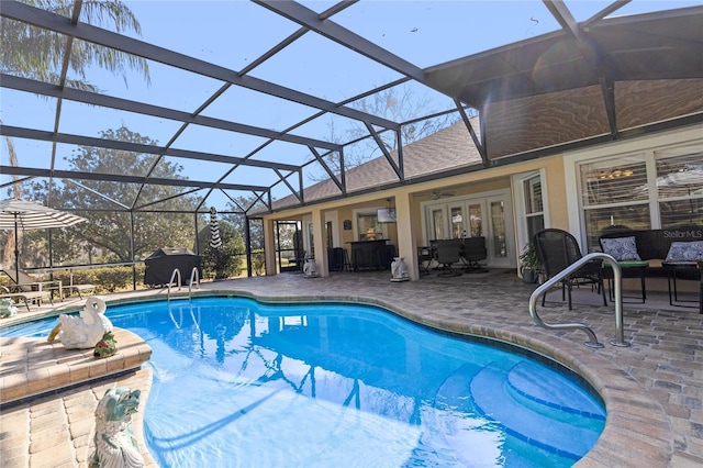 view of pool with a grill, a lanai, and a patio