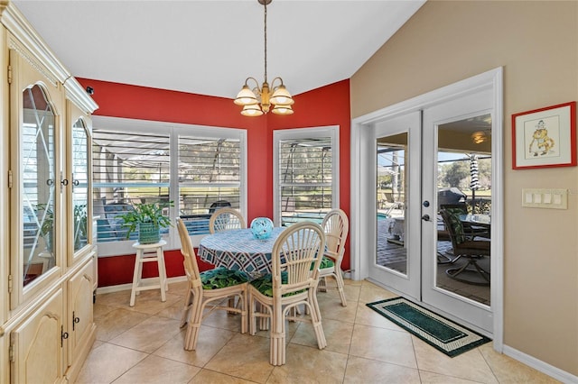 dining room featuring light tile patterned flooring, a healthy amount of sunlight, a notable chandelier, and french doors