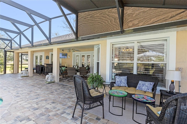 view of patio / terrace with french doors, ceiling fan, outdoor lounge area, and a lanai