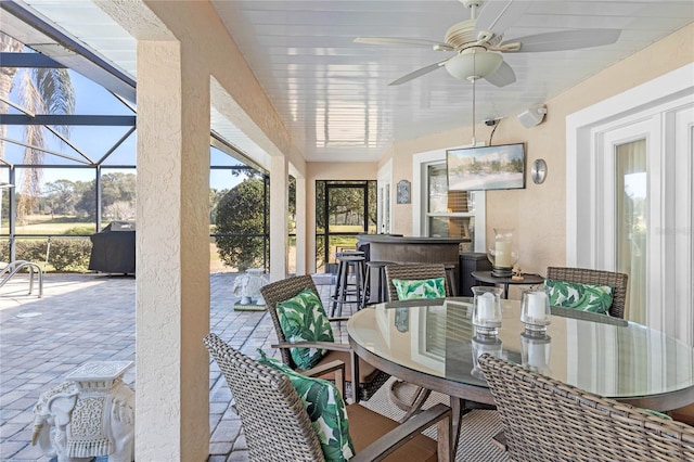 sunroom featuring ceiling fan