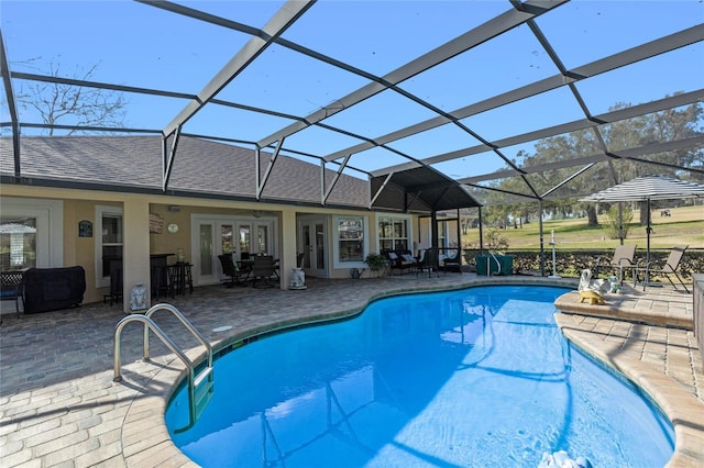 view of pool with a lanai, a patio area, and french doors