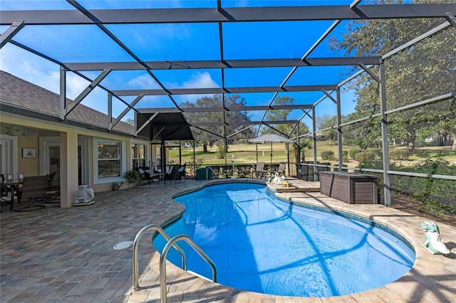 view of pool with a patio and glass enclosure